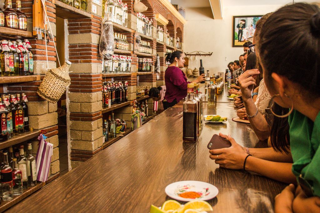 Tourists trying mezcal in a store